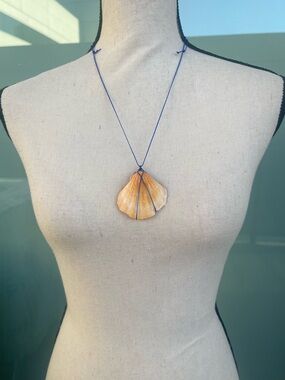 Handmade Orange Shell Wire Wrapped Necklace on a Blue Nylon Cord